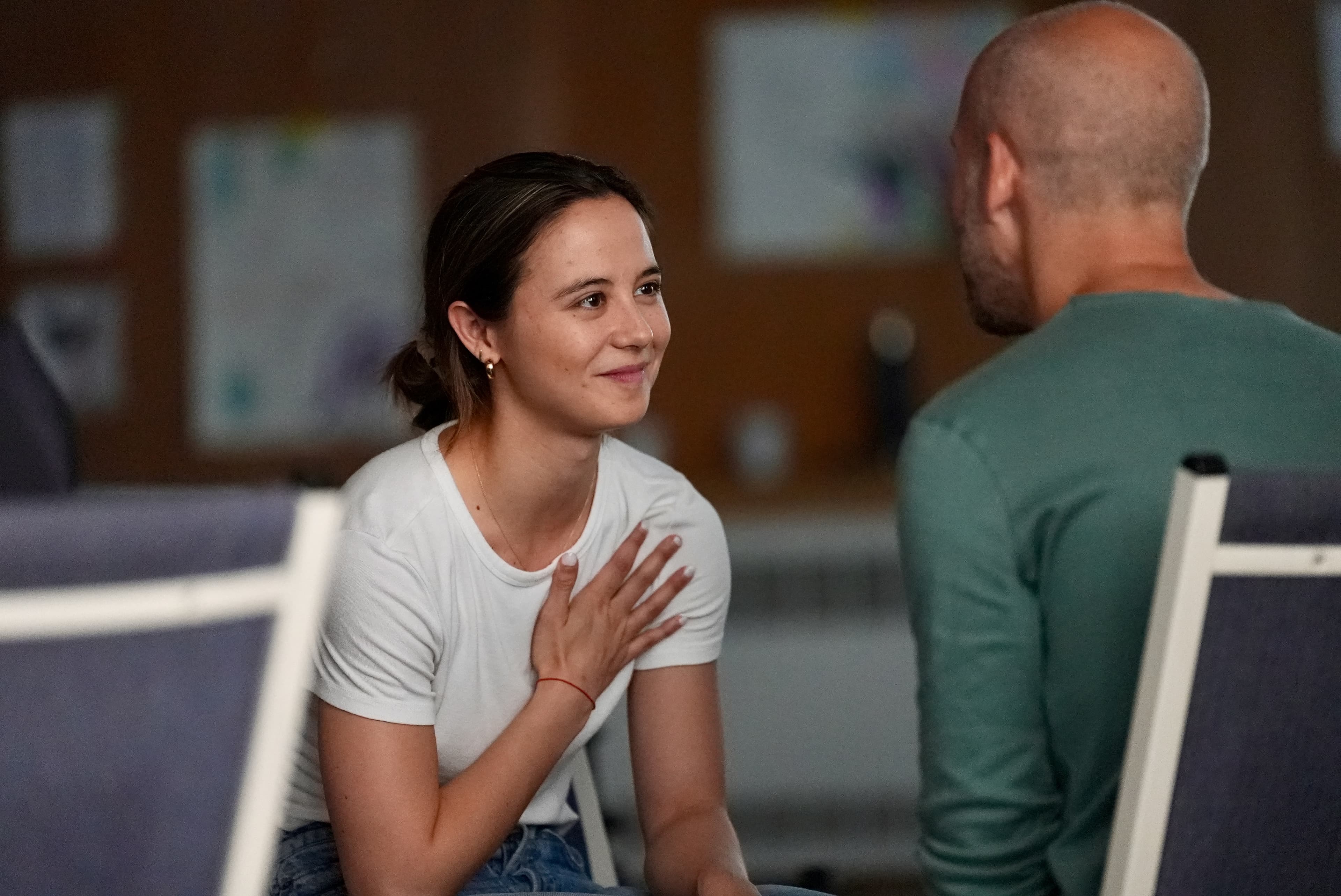 A camper with a hand on her heart in an emotional session